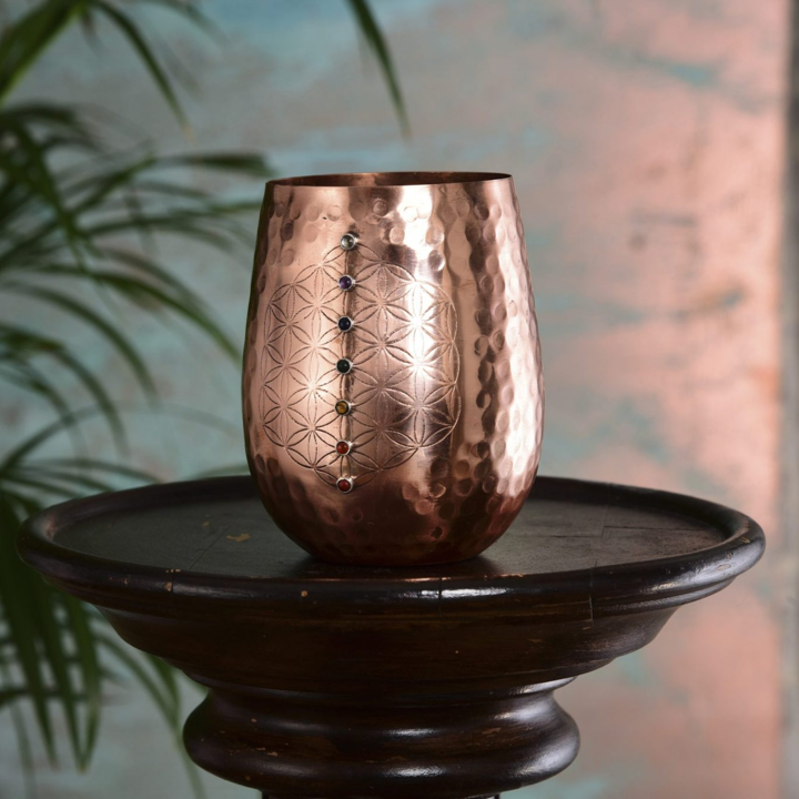 This 16oz capacity copper water cup is beautifully and sustainably made and offers you the health benefits of copper in every mindful sip.

Copper helps reduce inflammation, promote collagen production to improve skin health, aid digestion helping with weight loss and alkalize water to name just a few.

This copper cup will naturally sterilize (kill harmful bacteria found in drinking water), alkalize and re-mineralize the water you drink from it. Meaning the quality of water you drink is significantly improved with additional health benefits.

Benefits of drinking water from a copper cup

 	Sterilizes your water, removing harmful bacteria found in drinking water
 	Alkalizes your water
 	Re-mineralizes your water
 	Aids digestion
 	Reduces inflammation
 	Produces anti-oxidants
 	Helps form collagen, improving skin health

We handcraft this water cup using pure copper. The process of engraving, welding and hand setting each stone in place occurs before the copper is lacquered so it won’t tarnish, maintaining it’s beautiful mirror finish.

 

 