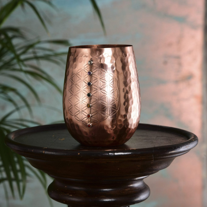 This 16oz capacity copper water cup is beautifully and sustainably made and offers you the health benefits of copper in every mindful sip.

Copper helps reduce inflammation, promote collagen production to improve skin health, aid digestion helping with weight loss and alkalize water to name just a few.

This copper cup will naturally sterilize (kill harmful bacteria found in drinking water), alkalize and re-mineralize the water you drink from it. Meaning the quality of water you drink is significantly improved with additional health benefits.

Benefits of drinking water from a copper cup

 	Sterilizes your water, removing harmful bacteria found in drinking water
 	Alkalizes your water
 	Re-mineralizes your water
 	Aids digestion
 	Reduces inflammation
 	Produces anti-oxidants
 	Helps form collagen, improving skin health

We handcraft this water cup using pure copper. The process of engraving, welding and hand setting each stone in place occurs before the copper is lacquered so it won’t tarnish, maintaining it’s beautiful mirror finish.

 

 